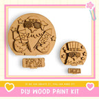 two wooden cutouts of American flags, one larger and one smaller, along with a sign that says "Born in the USA". The text below the cutouts reads "DIY WOOD PAINT KIT" and "If we can create it, you can make it!".