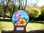 a picture of a flower vase with a butterfly on it