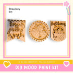 three wooden paint kits, each with a unique design and text. The kits appear to be made of wood and are designed for creating custom paint designs. The kits are presented in a collage format, with the text "DIY WOOD PAINT KIT" displayed prominently.