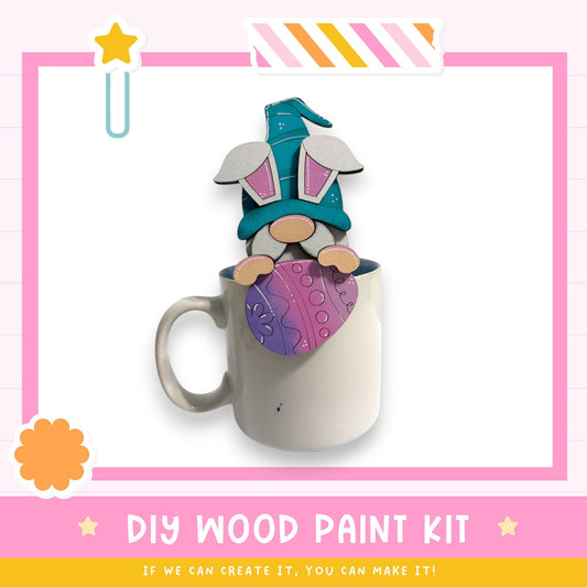 A mug with a wooden gnome figure painted on it, sitting inside the mug.