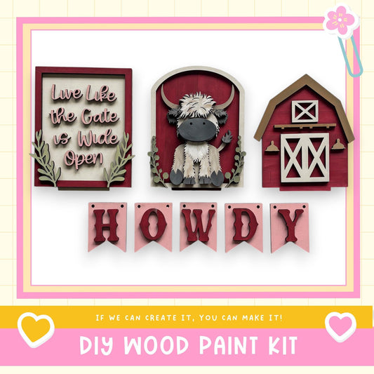 The image is a collage of three wooden wall hangings, including a barn, a cow, and the word "HOWDY". The text "Live like the Gate is Wide Open" is displayed on the left side, and the phrase "If we can create it, you can make it!" is shown on the right side. The image is described as a DIY wood paint kit, suggesting that the viewer can create their own wooden wall hangings.