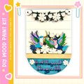 The image is a colorful and vibrant painting kit featuring a wooden frame with a decorative border. The frame is adorned with a variety of flowers and birds, creating a lively and cheerful atmosphere. The kit appears to be designed for children, as indicated by the playful and colorful nature of the artwork.