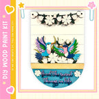 The image is a colorful and vibrant painting kit featuring a wooden frame with a decorative border. The frame is adorned with a variety of flowers and birds, creating a lively and cheerful atmosphere. The kit appears to be designed for children, as indicated by the playful and colorful nature of the artwork.