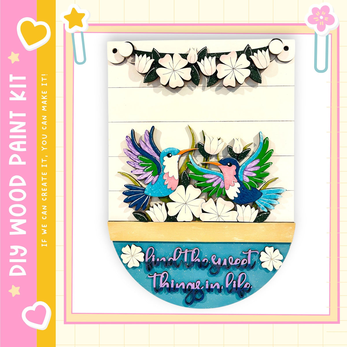 The image is a colorful and vibrant painting kit featuring a wooden frame with a decorative border. The frame is adorned with a variety of flowers and birds, creating a lively and cheerful atmosphere. The kit appears to be designed for children, as indicated by the playful and colorful nature of the artwork.