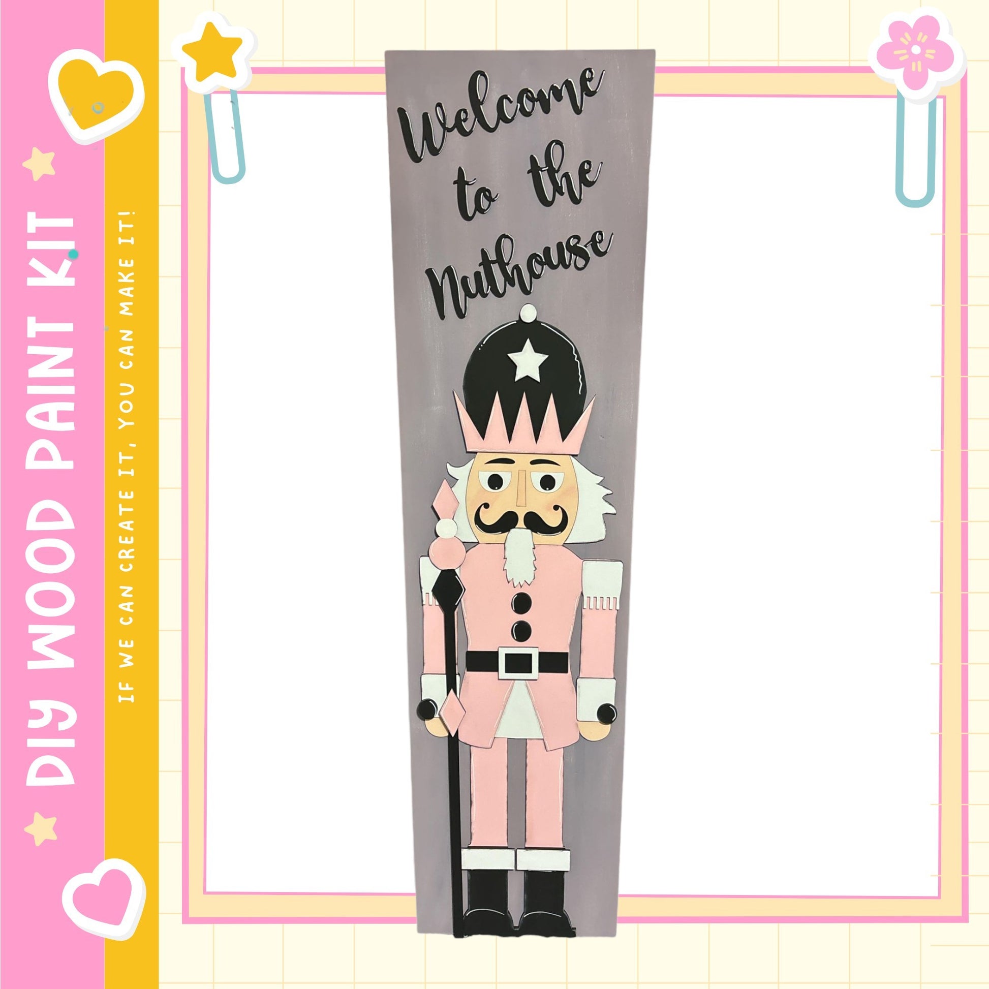 a nutcracker character with a star on its head, standing in a frame with a pink and yellow border.