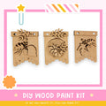 three wooden wall hangings with designs on them