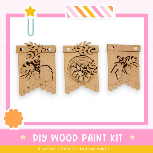 three wooden wall hangings with designs on them