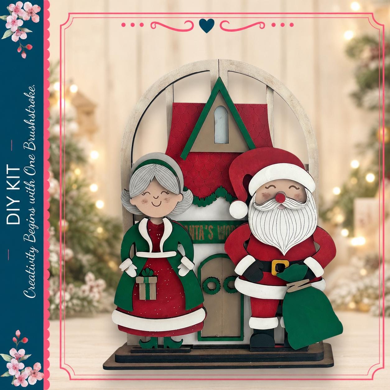 A DIY kit featuring a Christmas-themed ornament with a Santa Claus and an elderly woman, set against a blurred background of holiday lights and trees.