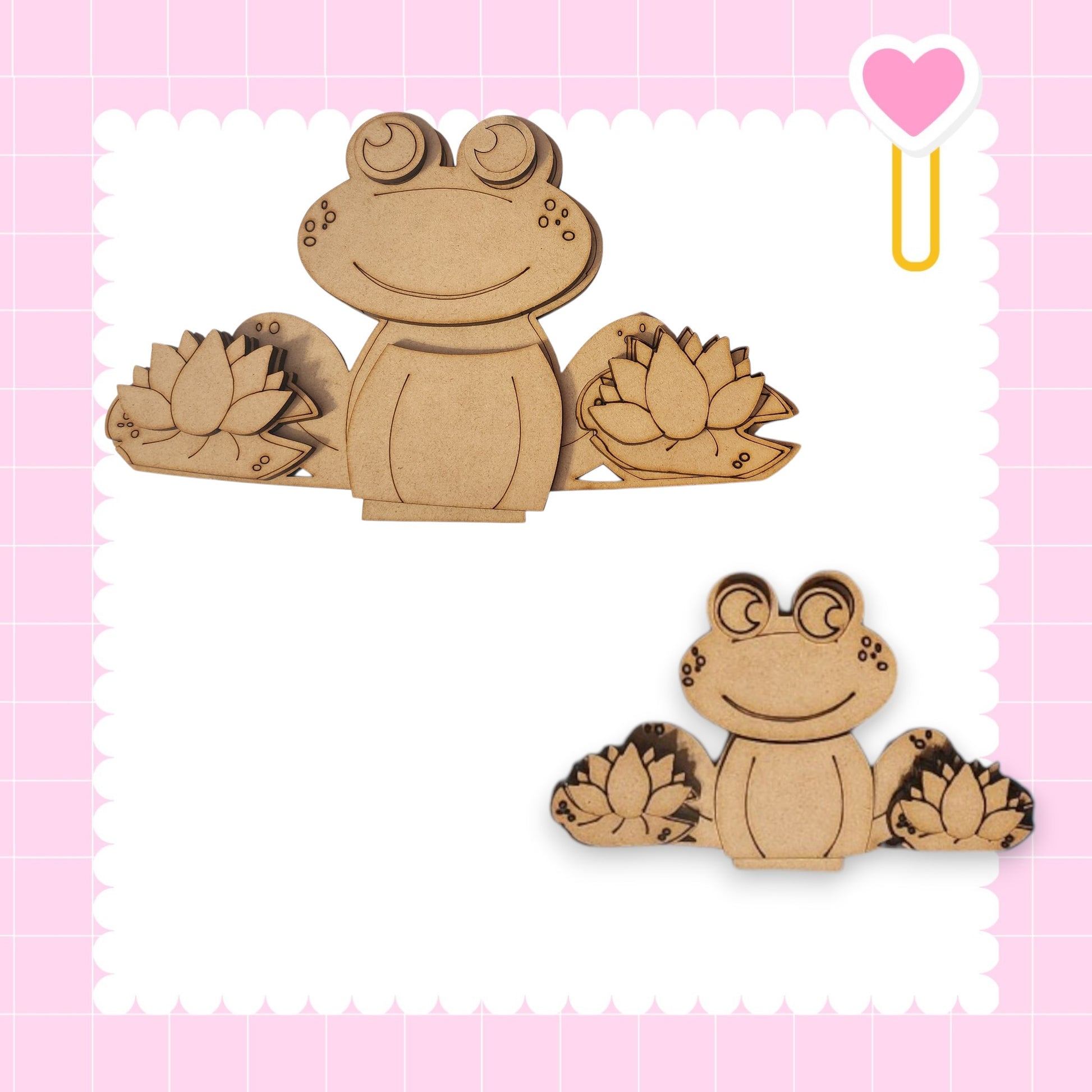 two wooden frog cutouts, one larger and one smaller, both with flower-like designs on their bodies.