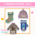 four knitted mittens and gloves are shown on a card