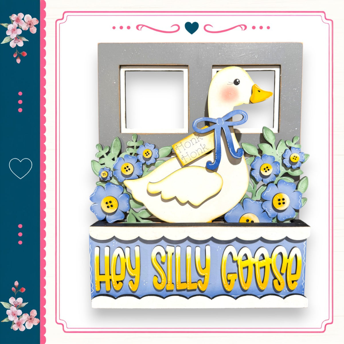 A decorative wooden frame with a cartoon goose and flowers, along with the text "Hey Silly Goose" written on it.
