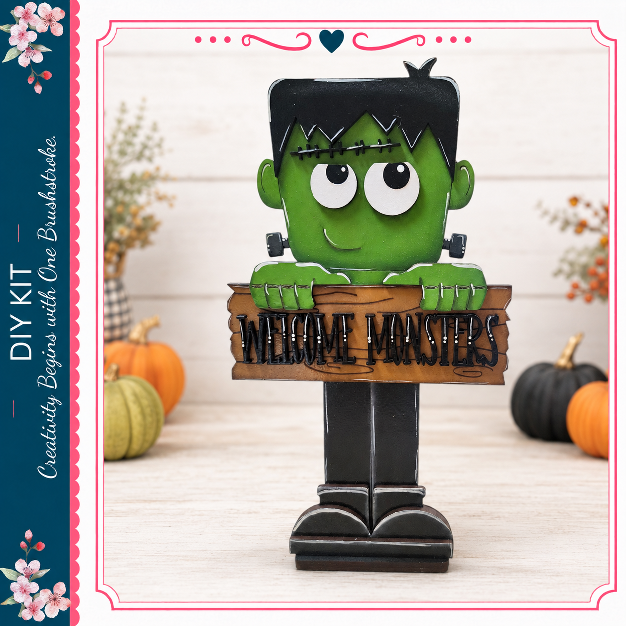 A green monster-like figure holding a wooden sign that says "Welcome Masters" in front of pumpkins and other fall decorations.