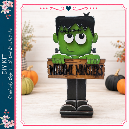 A green monster-like figure holding a wooden sign that says "Welcome Masters" in front of pumpkins and other fall decorations.