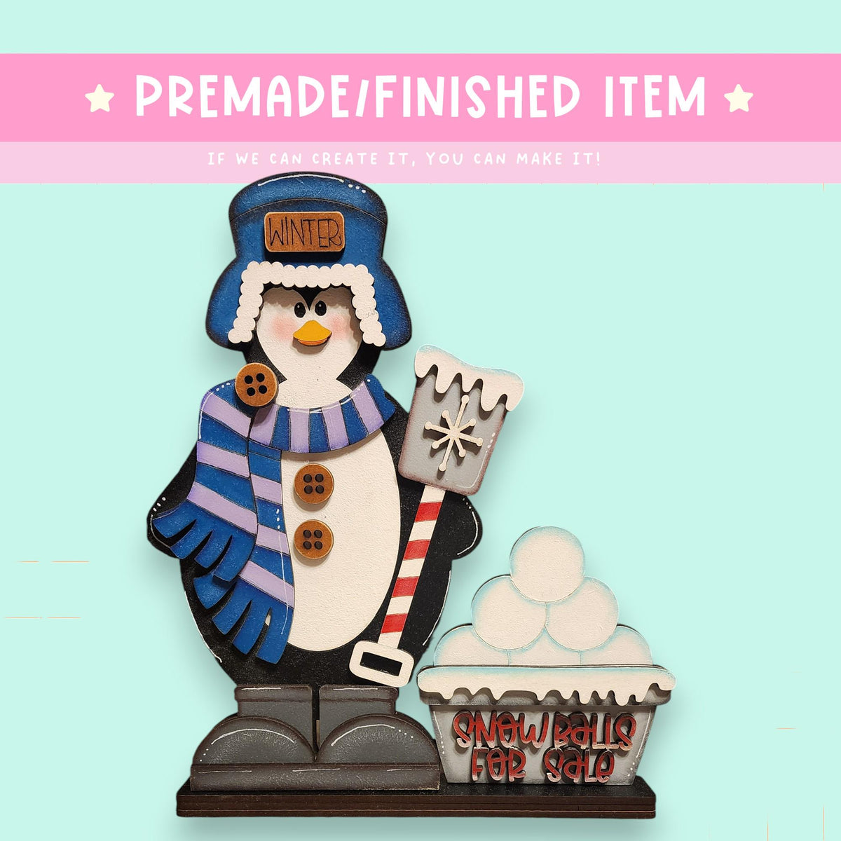 A wooden snowman figure holding a snow shovel and standing next to a snowman figure holding a snowman figure.