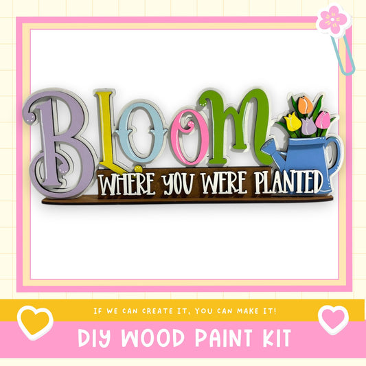 a DIY wood paint kit with a colorful sign that says "Bloom" and "Where you were planted".