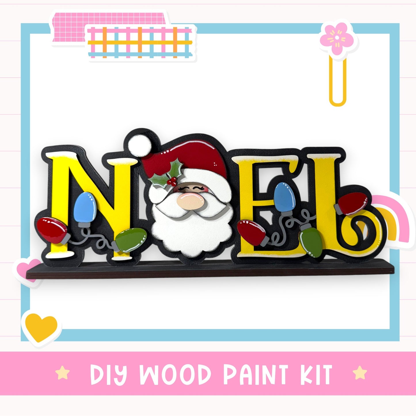 A DIY wood paint kit featuring a wooden sign with the word " Noel " painted on it, along with a Santa Claus face and Christmas lights.