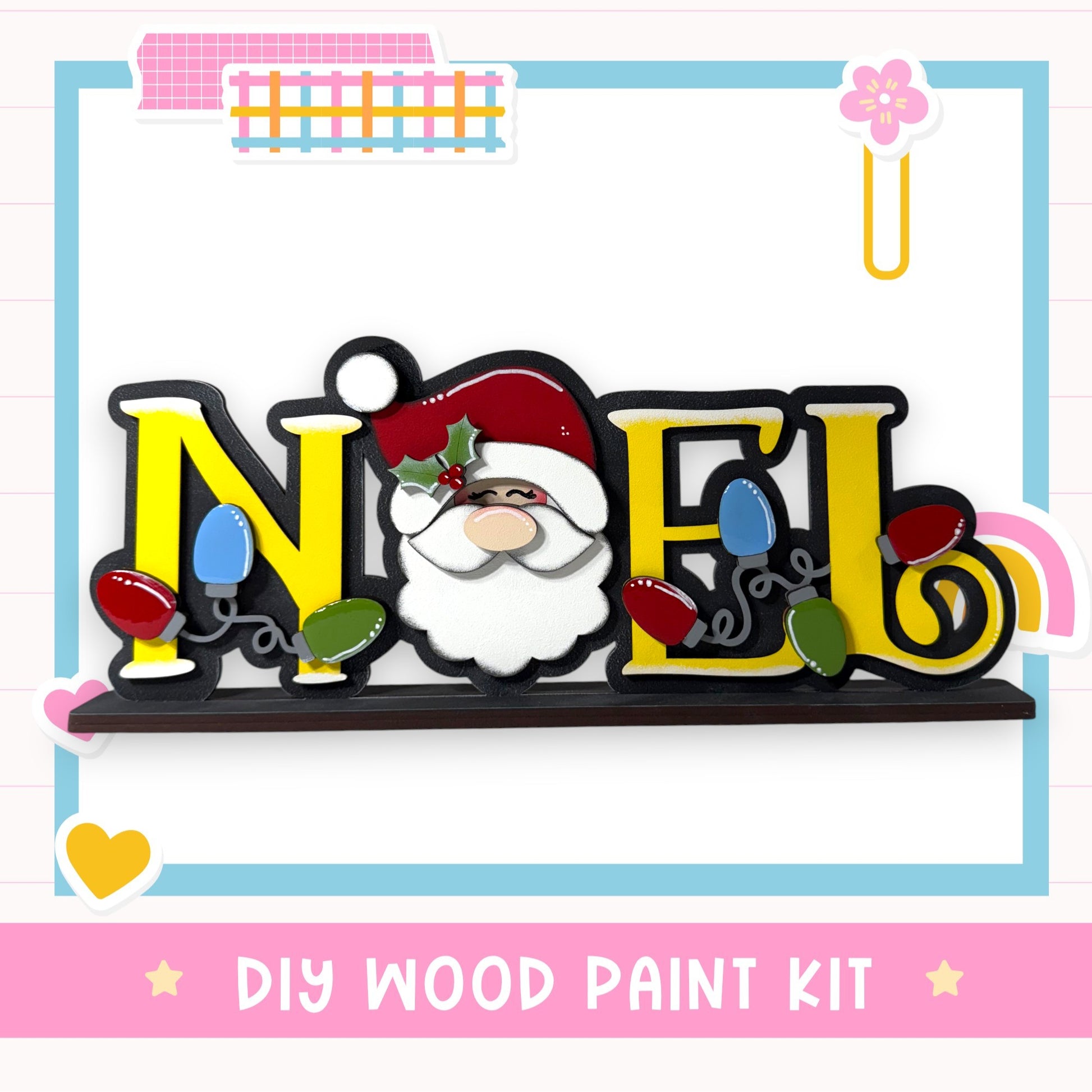 A DIY wood paint kit featuring a wooden sign with the word " Noel " painted on it, along with a Santa Claus face and Christmas lights.