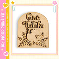 A wooden sign with the text "Give Thanks" carved into it, surrounded by leaves and a turkey silhouette.