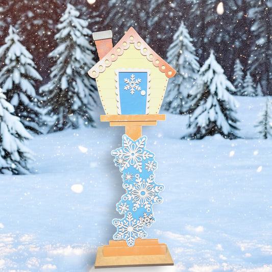 a bird house with snowflakes on it in the snow