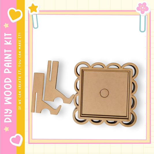 a DIY wood paint kit, including a wooden frame and a wooden piece, all set against a pink and yellow background with decorative elements.