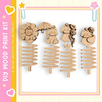 a collection of four wooden spring-like objects, each with a unique design and character on it.