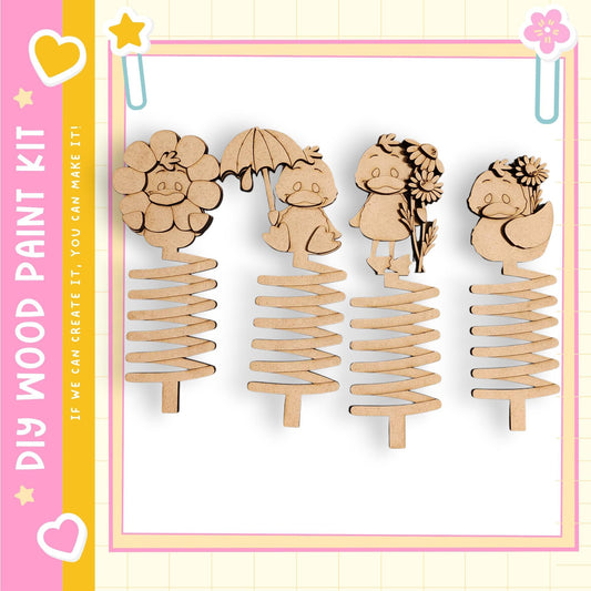 a collection of four wooden spring-like objects, each with a unique design and character on it.