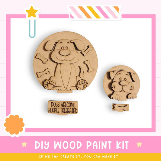 a DIY wood paint kit for creating wooden dog-themed decorations, including two wooden dog cutouts and a sign that says "DOGS WELCOME PEOPLE TOLERATED".