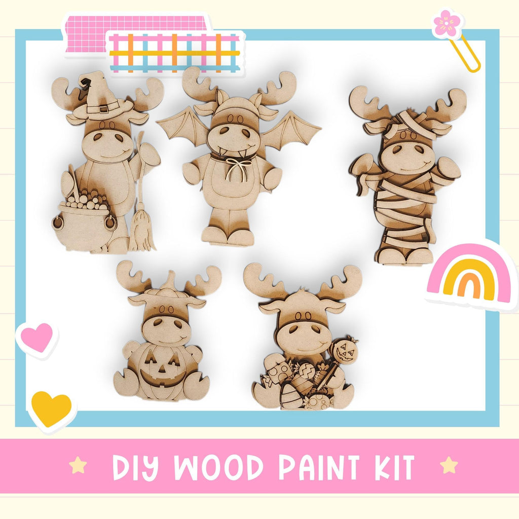 The image is a DIY wood paint kit featuring five wooden animal figurines, including moose, bats, and a pumpkin.