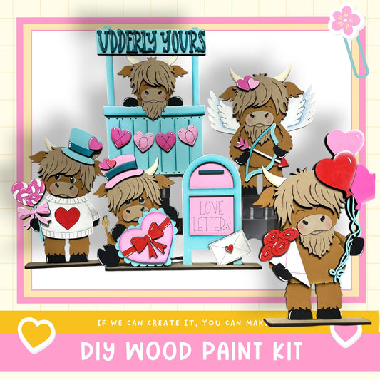 The image is a collage featuring a group of wooden toy animals, including a cow, a horse, and a dog, along with various heart-shaped and heart-studded objects. The collage is set against a pink and white background, and there is text at the bottom that reads "DIY WOOD PAINT KIT" and "IF WE CAN CREATE IT, YOU CAN MAKE."