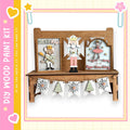 A wooden shelf with a nativity scene and a nutcracker figure on it, along with a banner of snowflakes and a small tree decoration.