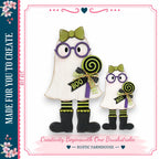 two whimsical, ghostly figures dressed in Halloween costumes, including purple glasses and green bows, holding lollipops. The caption below the image reads "Creativity Begins with One Brushstroke - Rustic Farmhouse".
