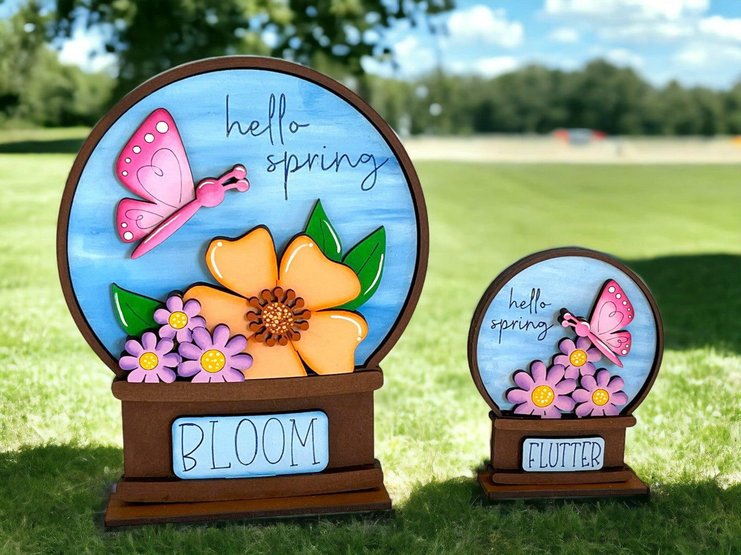 a couple of vases sitting on top of a lush green field