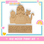 a wooden cutout of a cartoon character with a rainbow in the background