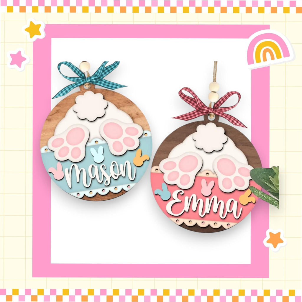 a picture of two wooden ornaments with a rainbow in the background