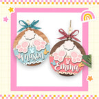 a picture of two wooden ornaments with a rainbow in the background