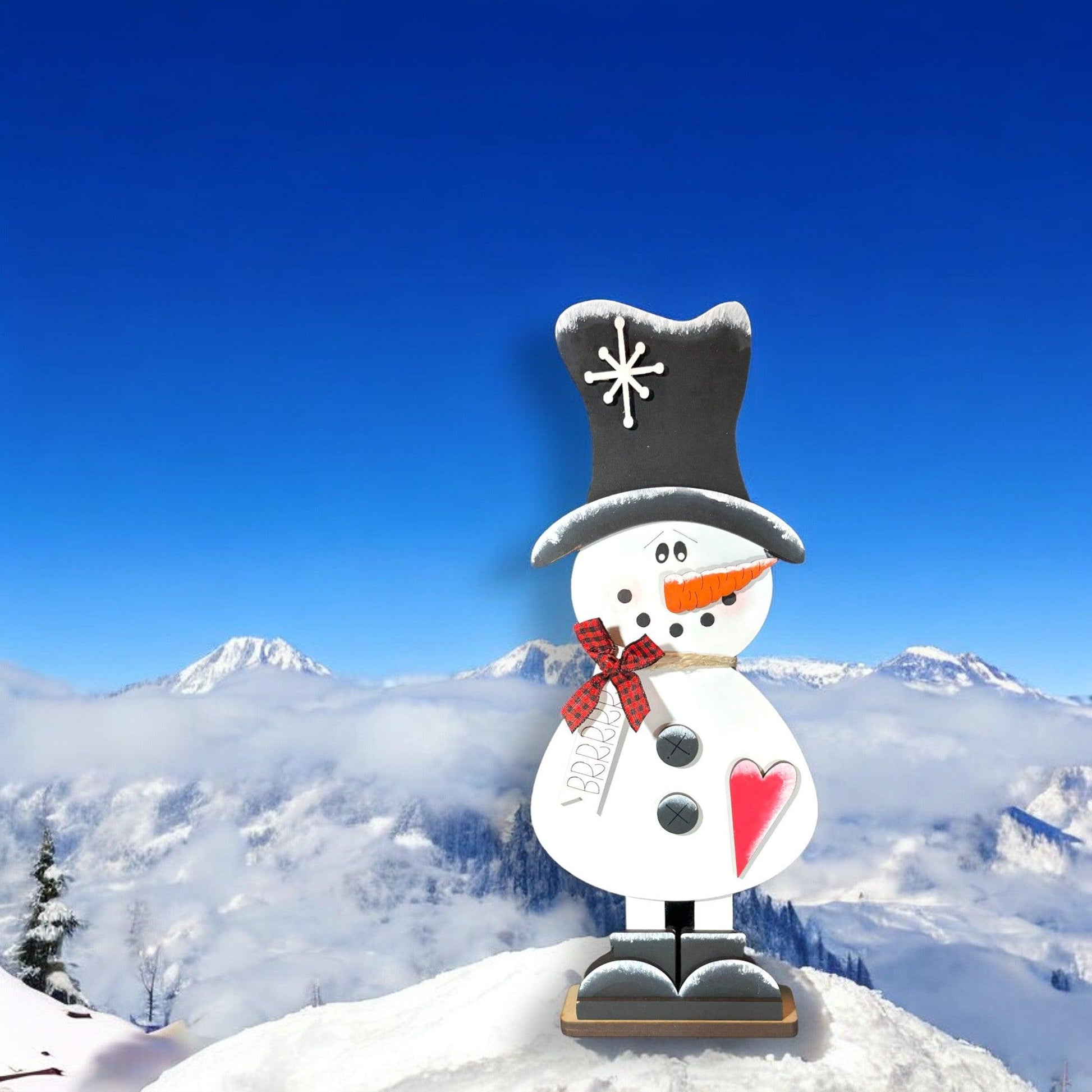 a snowman on top of a snowy mountain