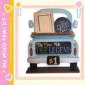 A wooden truck with a picture frame on top, displaying a message about a father.