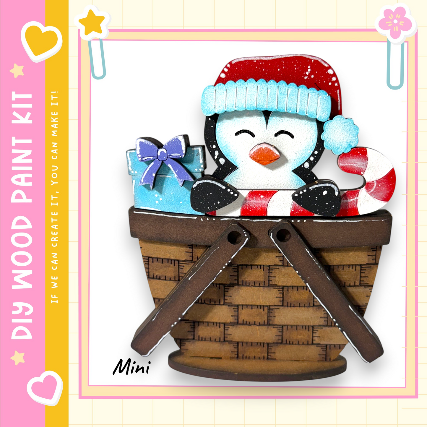 A wooden paint kit depicting a penguin wearing a red hat and holding a gift, sitting in a brown basket.