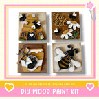 The image is a collage of four wooden paint kits, each featuring a different design related to bees and honey. The kits include a beehive, a honey jar, a bee, and a bee with a heart. The collage is framed with a pink border and the text "DIY WOOD PAINT KIT" is displayed at the bottom.