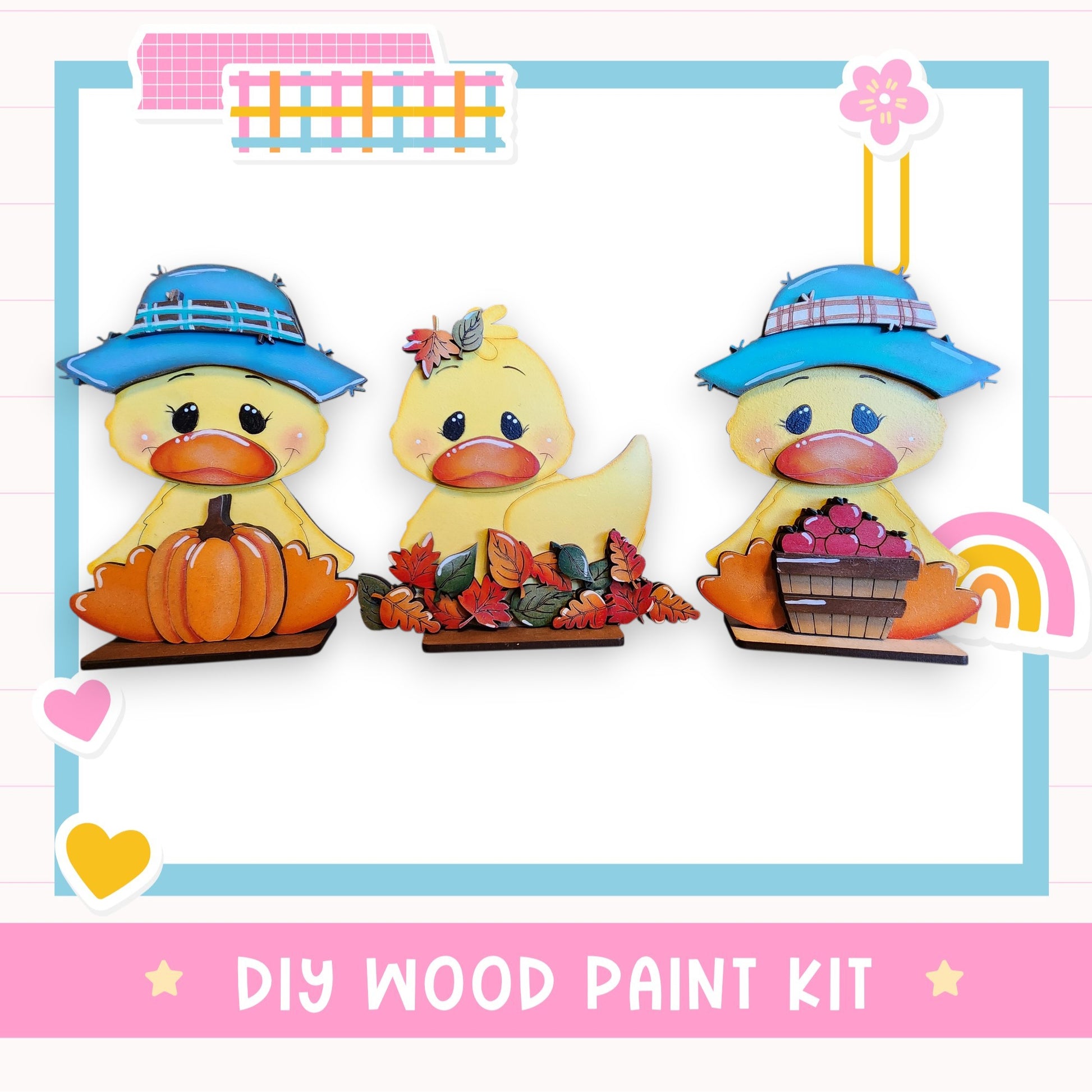 three wooden duck figurines, each wearing a hat and holding a different object, such as a pumpkin, a basket of fruit, and a flower. The image also includes a text box that reads "DIY WOOD PAINT KIT" and a heart symbol.