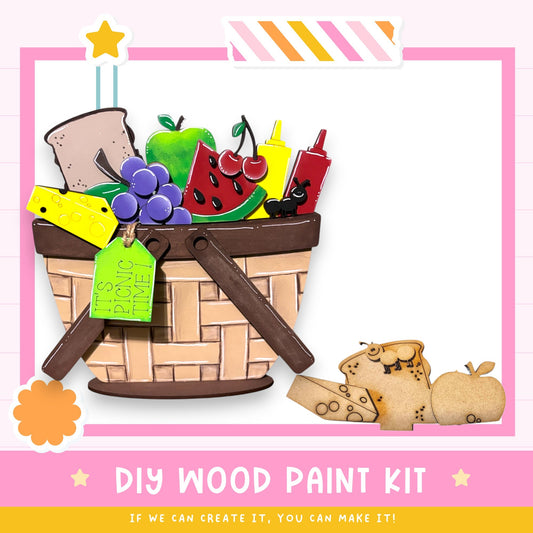 The image is a colorful illustration of a basket filled with various fruits and vegetables, along with a sign that says "IT'S PICNIC TIME". The image also includes a DIY wood paint kit and a message encouraging creativity, stating that if one can create it, they can make it.