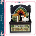 A DIY kit for creating a St. Patrick's Day-themed decoration, featuring a rainbow, shamrocks, and the number 17.
