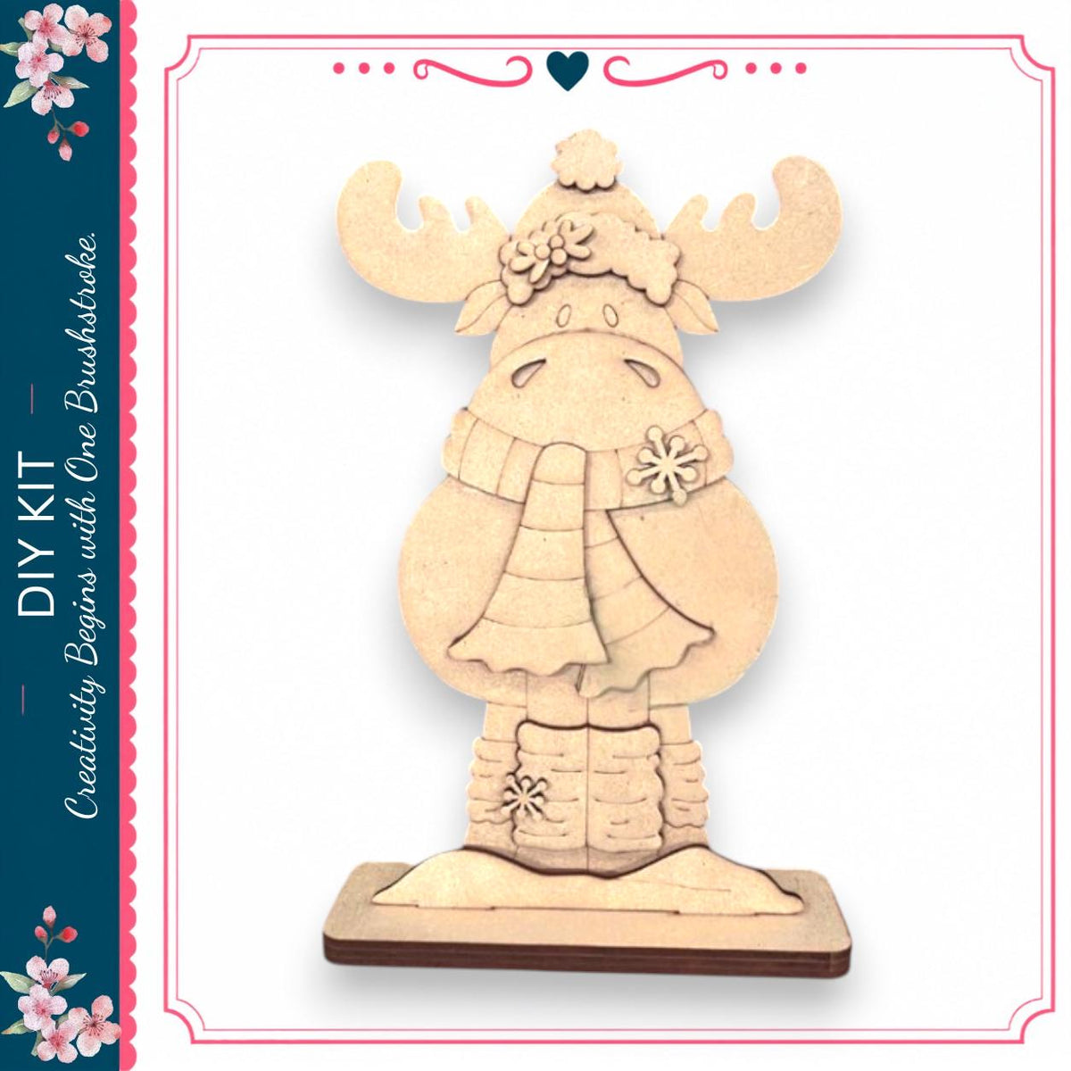 A wooden snowman decoration with antlers and a scarf, sitting on a wooden base.