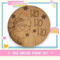 a picture of a wooden santa clause with a rainbow in the background