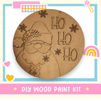 a picture of a wooden santa clause with a rainbow in the background