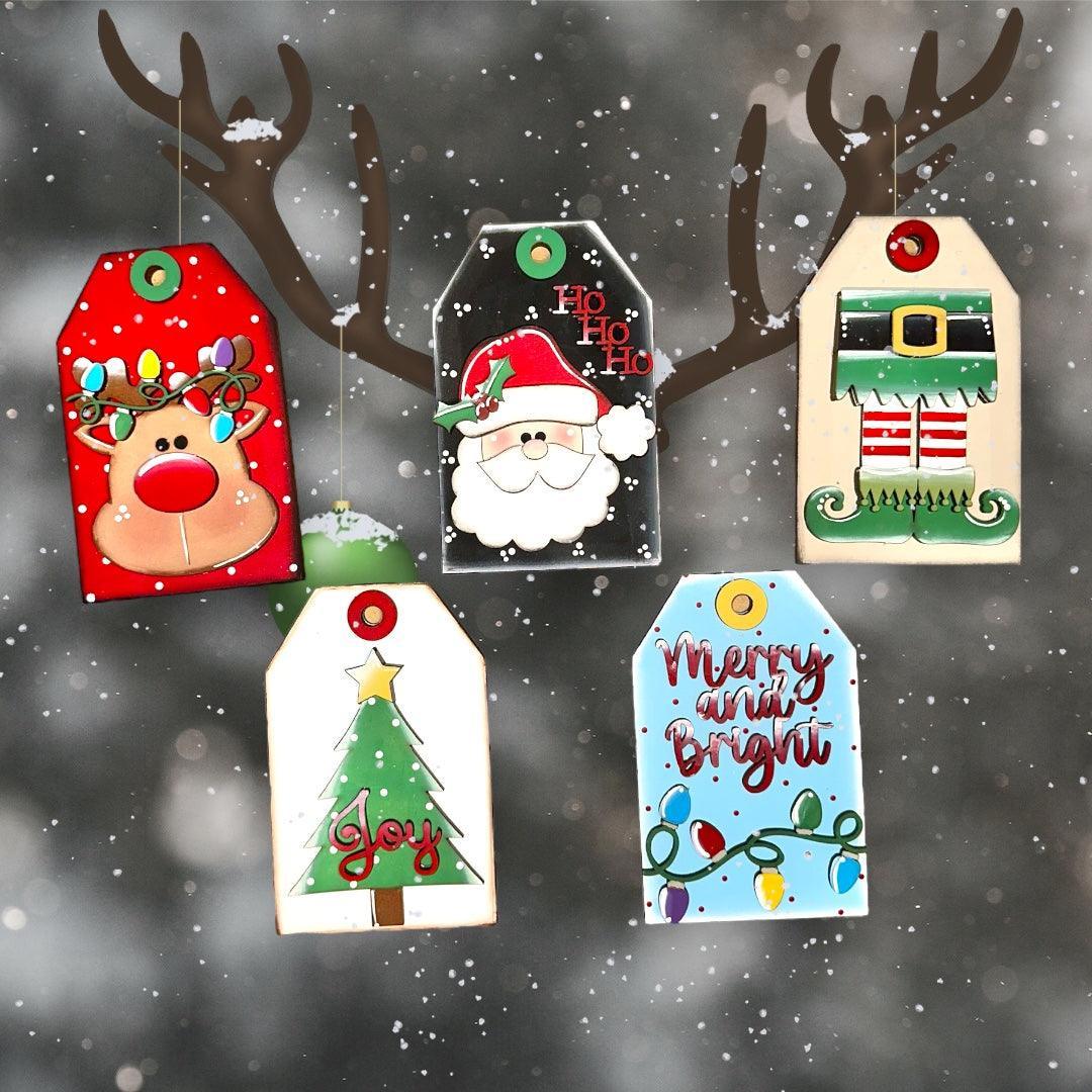a group of christmas tags hanging from a tree