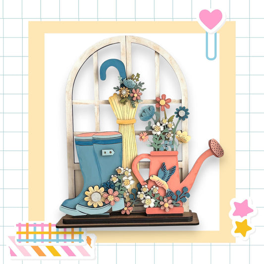 A wooden window sill with a vase of flowers, a pair of blue rain boots, and a pink watering can, all set against a white background with a grid pattern.
