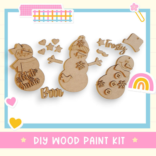 a group of wooden cutouts of snowmen