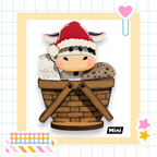 A wooden basket with a cow wearing a Santa hat and holding a milk carton and cookies.