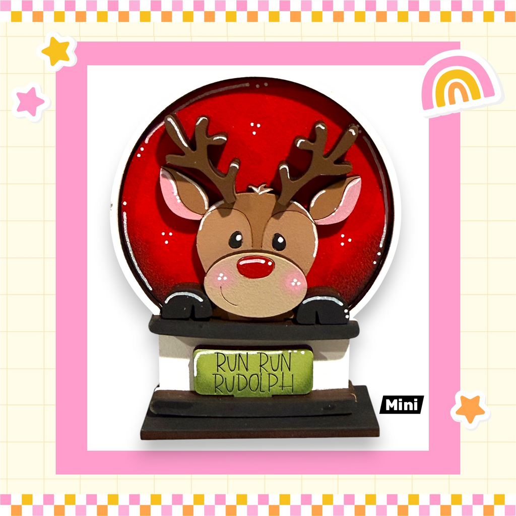 A red snow globe with a cartoon reindeer inside, surrounded by a pink border and decorated with stars and a rainbow.